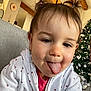 Erynn participe au concours pour gagner de l'argent avec cette photo : child, christmas_tree, cozy, cute, face, holiday_decor, home, indoor, person, pigtails, playful, portrait, red_shirt, smiling, sofa, toddler, tongue, white_jacket, wooden_beams, young_child