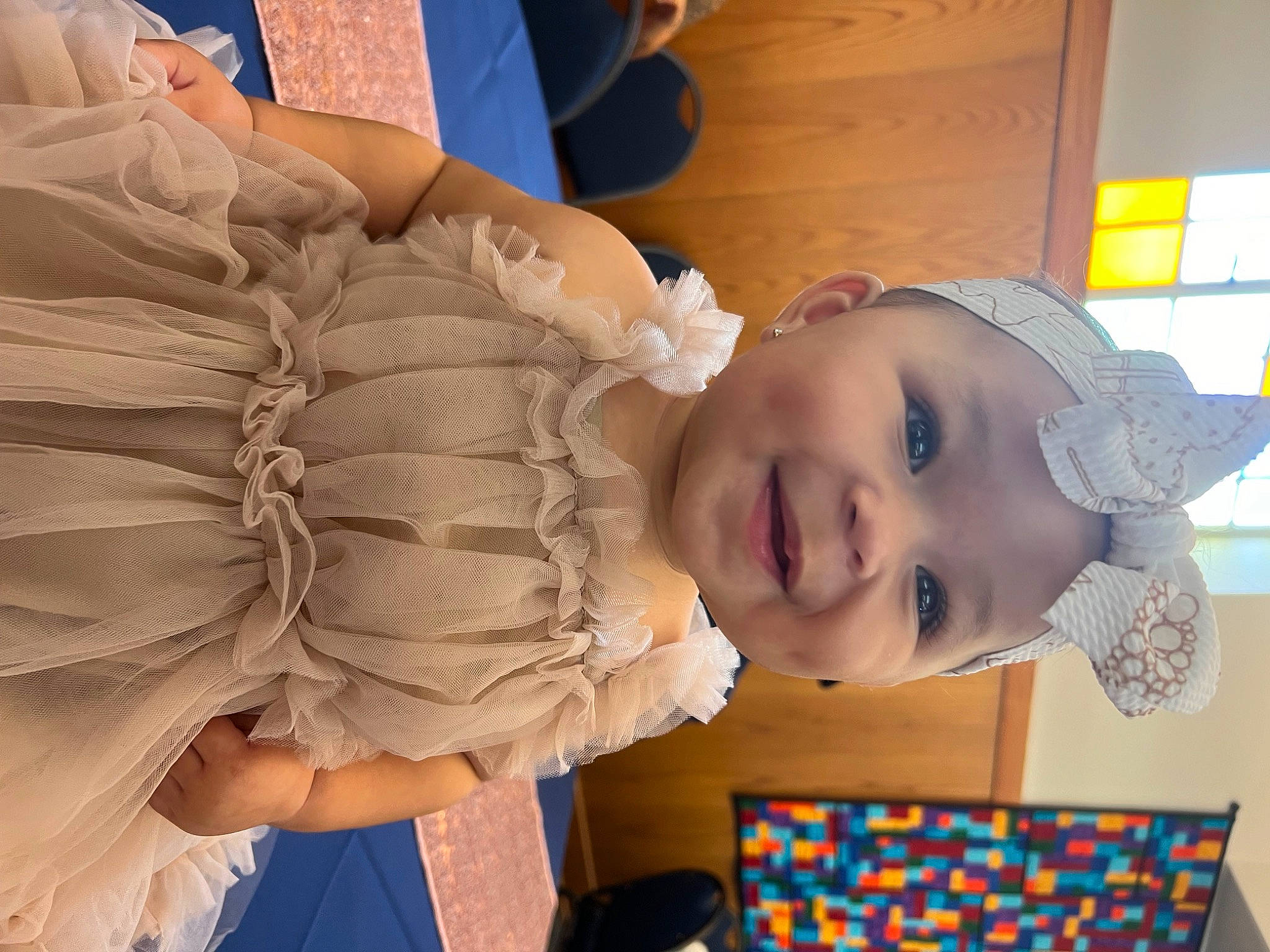 Saylor is registered to the contest to win money with this photo: abdomen, baby, baby_laughing, baby_products, baby_toddler_clothing, child, flooring, fun, happy, hat, headwear, joy, leisure, mouth, pattern, person, play, room, sitting, smile