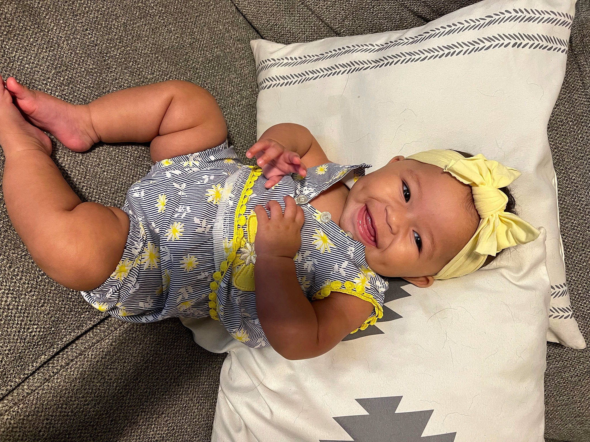 Saylor is registered to the contest to win money with this photo: arm, baby, baby_toddler_clothing, comfort, cool, elbow, facial_expression, finger, gesture, hand, happy, headgear, headwear, joy, pattern, person, skin, sleeve, smile, thigh