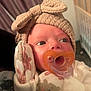 Marceline Rae joined the competition — help win amazing prizes! baby, infant, pacifier, headband, bow, mittens, cute, teddy_bear_print, close_up, portrait, indoors, crib, curtains, sleepwear, newborn, soft_lighting, child, person, face, apparel