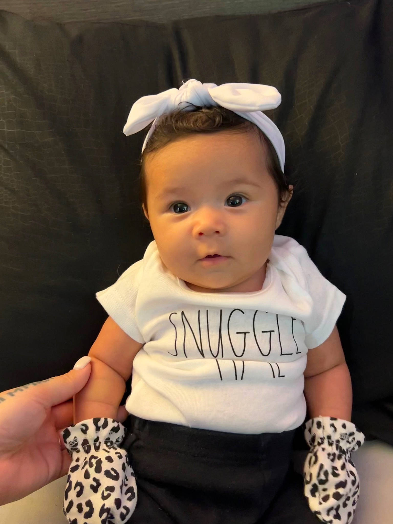 Amya is registered to the contest to win money with this photo: baby, baby_toddler_clothing, cheek, child, eyelash, face, fashion_accessory, hair_accessory, happy, headband, jewellery, neck, necklace, pattern, person, sleeve, smile, t_shirt, toddler, white