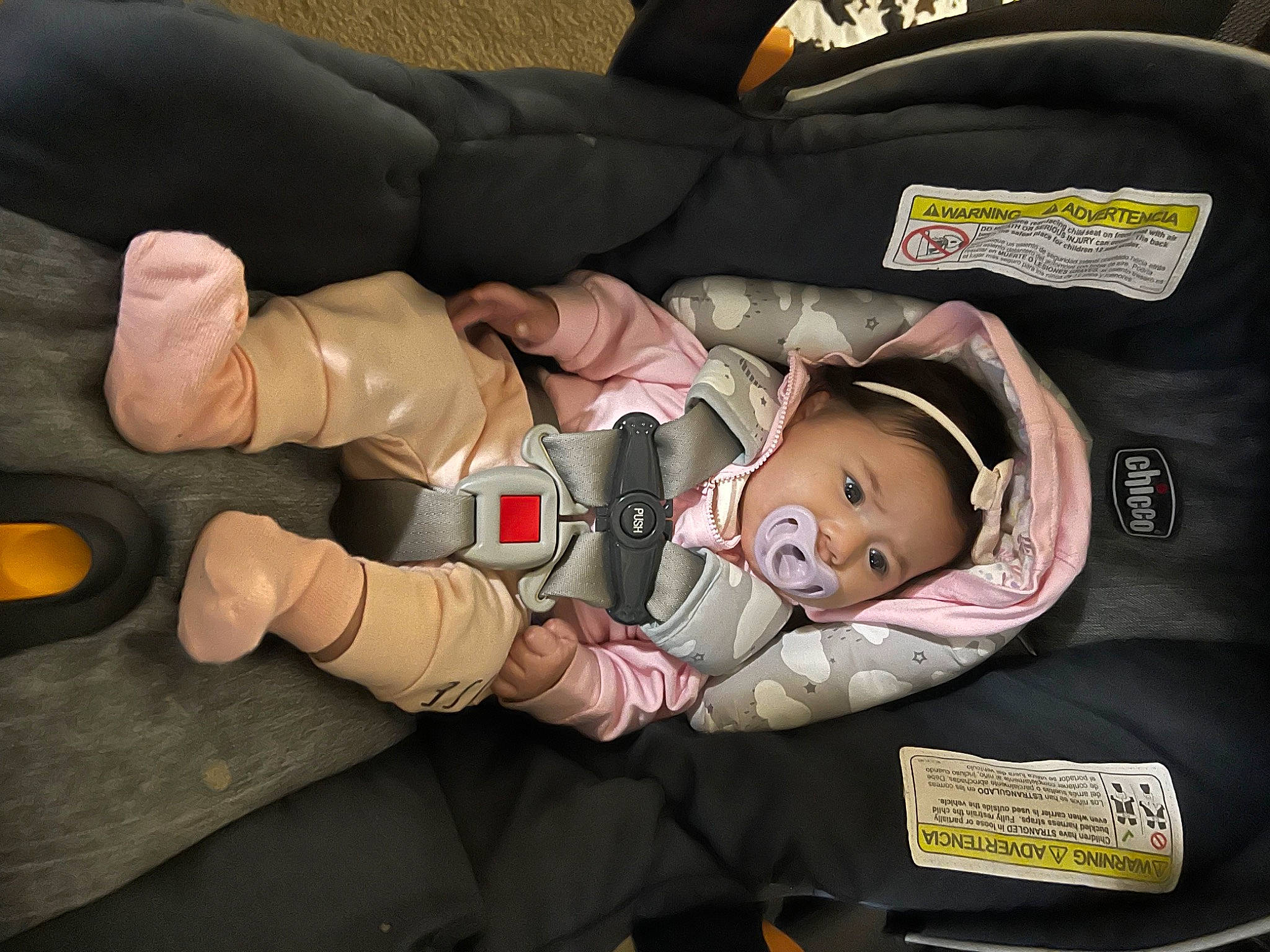 Amya is registered to the contest to win money with this photo: auto_part, baby, baby_carriage, baby_products, baby_safety, baby_toddler_clothing, car_seat, child, comfort, gesture, person, sitting, thumb, toddler, wrist