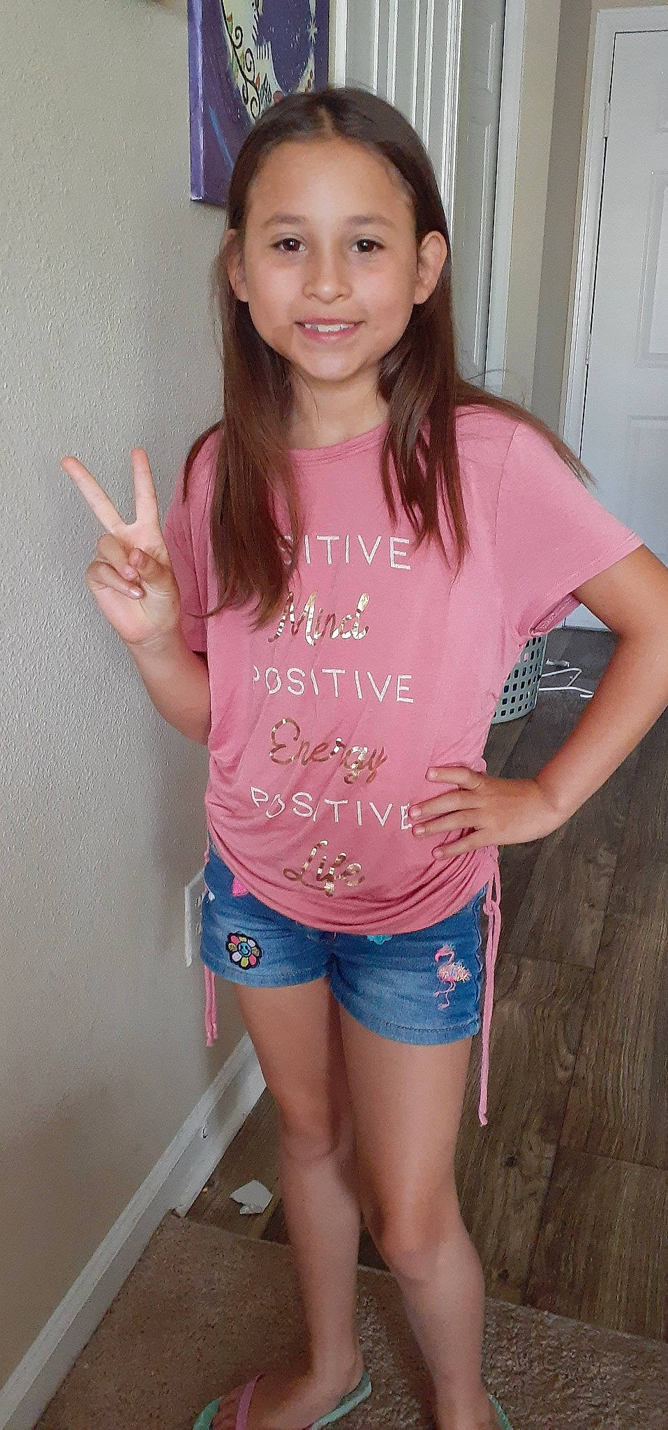 Mia is registered to the contest to win money with this photo: beauty, blouse, clothing, finger, gesture, joy, leg, long_hair, neck, person, pink, shorts, shoulder, sleeve, t_shirt, thigh, thumb, top, waist