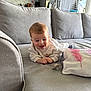 Gabriel participe au concours pour gagner de l'argent avec cette photo : baby, infant, smiling, couch, pillow, pacifier, living_room, home_interior, clothing, child, happy, face, furniture, soft_toys, relaxing, indoors, cute, toddler, blanket, cozy