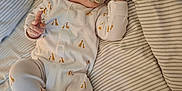 Louie joined the competition — help win amazing prizes! baby, bed, child, cozy, cute, face, giraffe_pattern, hand, indoors, infant, lying_down, newborn, onesie, pacifier, peaceful, portrait, resting, sleeping, soft_light, striped_bedding