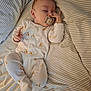 Louie joined the competition — help win amazing prizes! baby, sleeping, pacifier, onesie, giraffe_pattern, bed, striped_bedding, infant, cute, hand, face, resting, cozy, child, peaceful, lying_down, soft_light, indoors, portrait, newborn