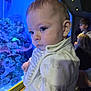 baby, child, aquarium, coral, marine_life, blue_light, indoor, people, portrait, curious, face, clothing, elephant_print, young_child, depth_of_field, blurry_background, observation, cute, infant, human