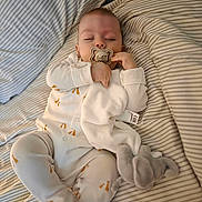 Louie joined the competition — help win amazing prizes! baby, sleeping, pacifier, blanket, stuffed_toy, bed, pajamas, infant, peaceful, cozy, striped_bedding, child, cute, rest, soft_toy, comfort, indoors, young_child, sleepwear, lying_down