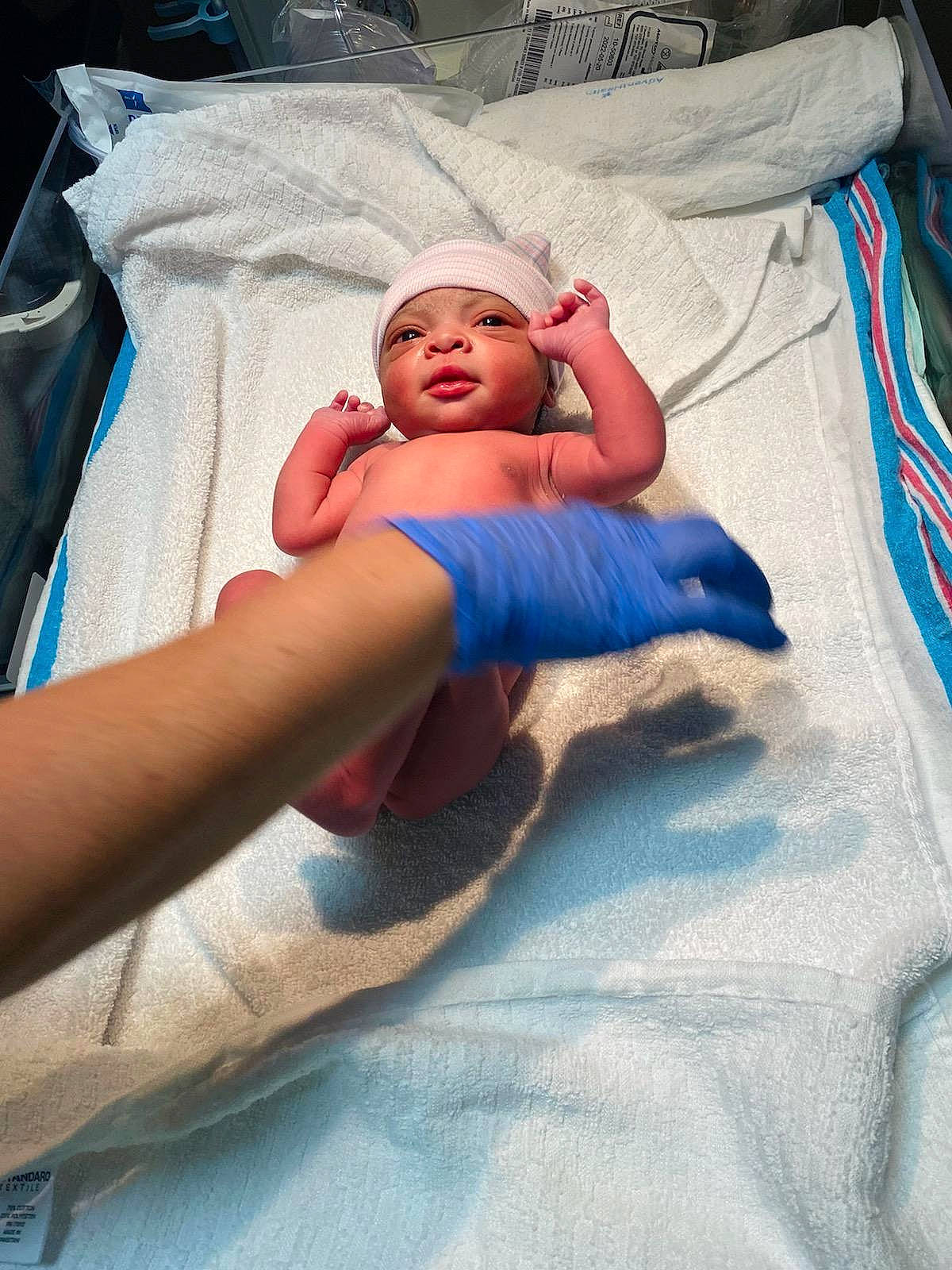 Zuri is registered to the contest to win money with this photo: abdomen, baby, baby_products, baby_safety, bed, bed_sheet, bedding, bedtime, blanket, child, comfort, event, hat, headwear, hospital, human_leg, linens, nap, person, room