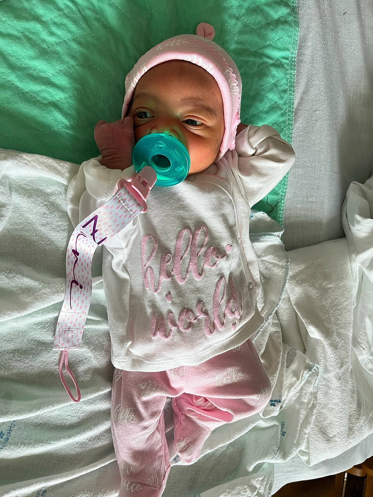 Zuri is registered to the contest to win money with this photo: baby, baby_products, baby_safety, baby_toddler_clothing, cheek, child, comfort, eye, face, goggles, hat, head, linens, magenta, pattern, person, personal_protective_equipment, room, sleeve, toddler