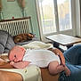 Noah participe au concours pour gagner de l'argent avec cette photo : baby, infant, person, couch, dog, indoor, living_room, glass_door, table, pillow, vase, pampas_grass, photo_frames, radiator, casual_clothing, relaxation, sleeping_dog, natural_light, home_decor, resting