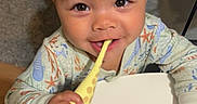 Kya is registered to the contest to win money with this photo: toddler, child, toy, giraffe, pajamas, table, face, smile, indoor, carpet, doorframe, hand, curious, bright_eyes, playing, baby, cute, young_child, person, home