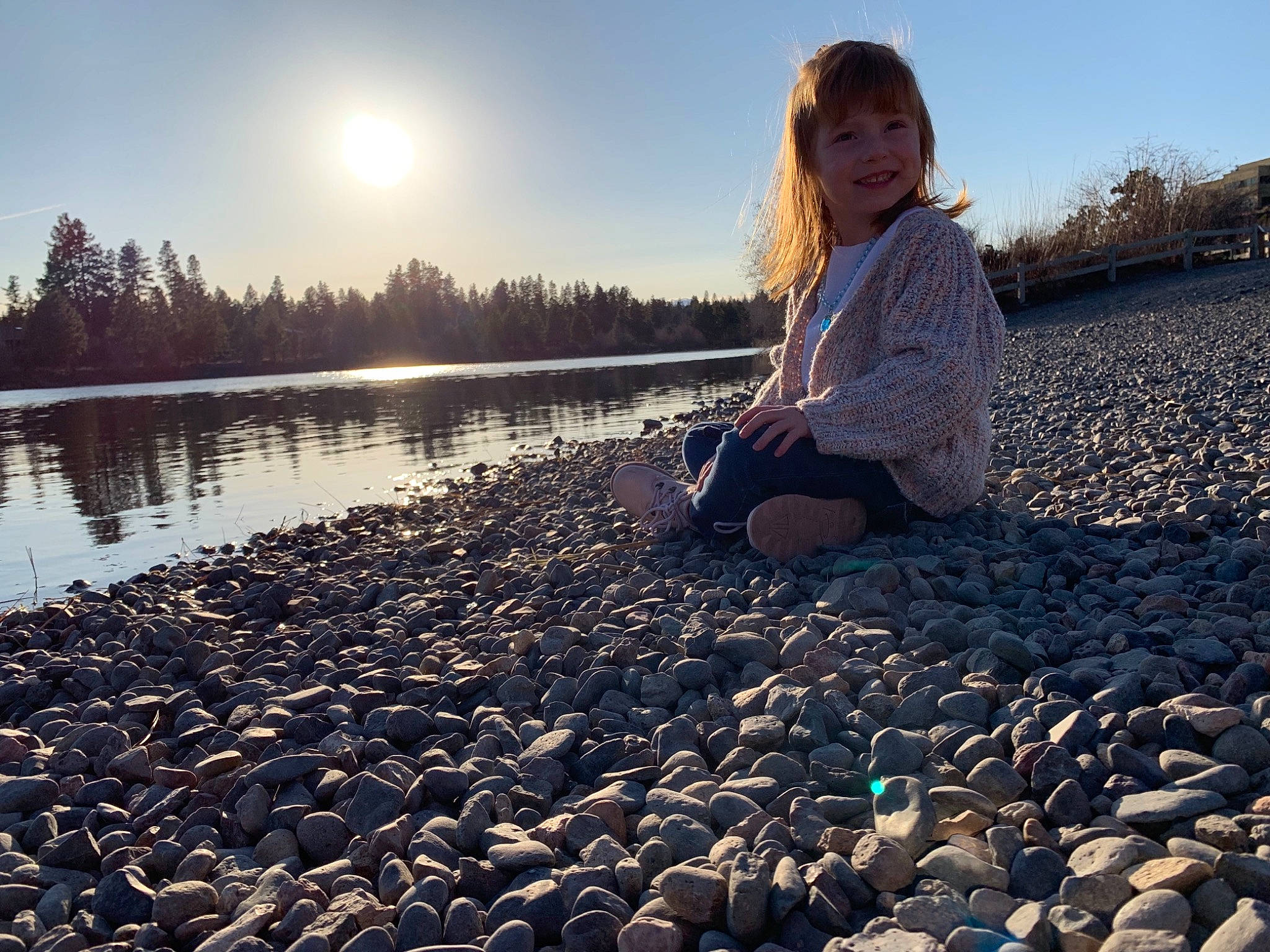 Bentley is registered to the contest to win money with this photo: bank, beach, child, cloud, evening, gravel, joy, leisure, pebble, people_in_nature, person, photography, play, river, rock, sea, shore, sitting, sky, sunlight