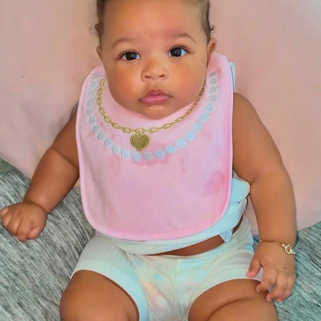 Sunshine joined the competition — help win amazing prizes! adorable, baby, bows, bracelet, child, chubby_legs, closeup, clothing, curly_hair, cute, expression, indoor, infant, looking_at_camera, pink_bib, portrait, sitting, skin, soft_cushion, young