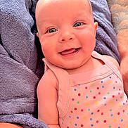 Renleigh is registered to the contest to win money with this photo: baby, infant, child, smiling, happy, portrait, face, eyes, indoor, blanket, cozy, pink_outfit, polka_dots, seated, close_up, adorable, soft_fabric, nursery, looking_at_camera, photography
