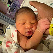 Janová joined the competition — help win amazing prizes! newborn, baby, infant, sleeping, hospital, blanket, hand, adult_hand, wristband, medical_equipment, bed, person, skin, closeup, comfort, rest, care, tenderness, hospital_room, portrait