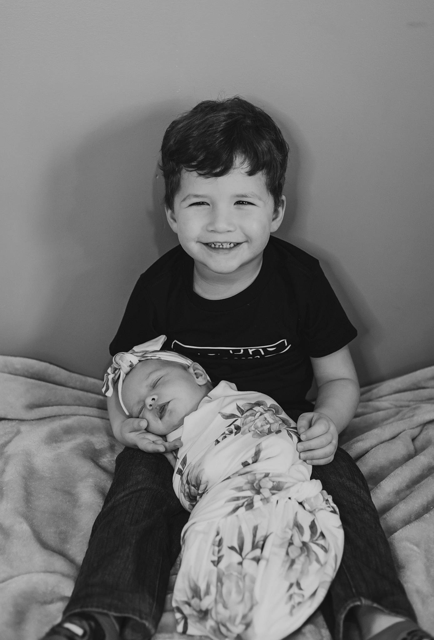 Patryk is registered to the contest to win money with this photo: baby, baby_toddler_clothing, black_and_white, comfort, elbow, facial_expression, flash_photography, fun, gesture, happy, human, joy, monochrome, monochrome_photography, person, skin, sleeve, smile, standing, style