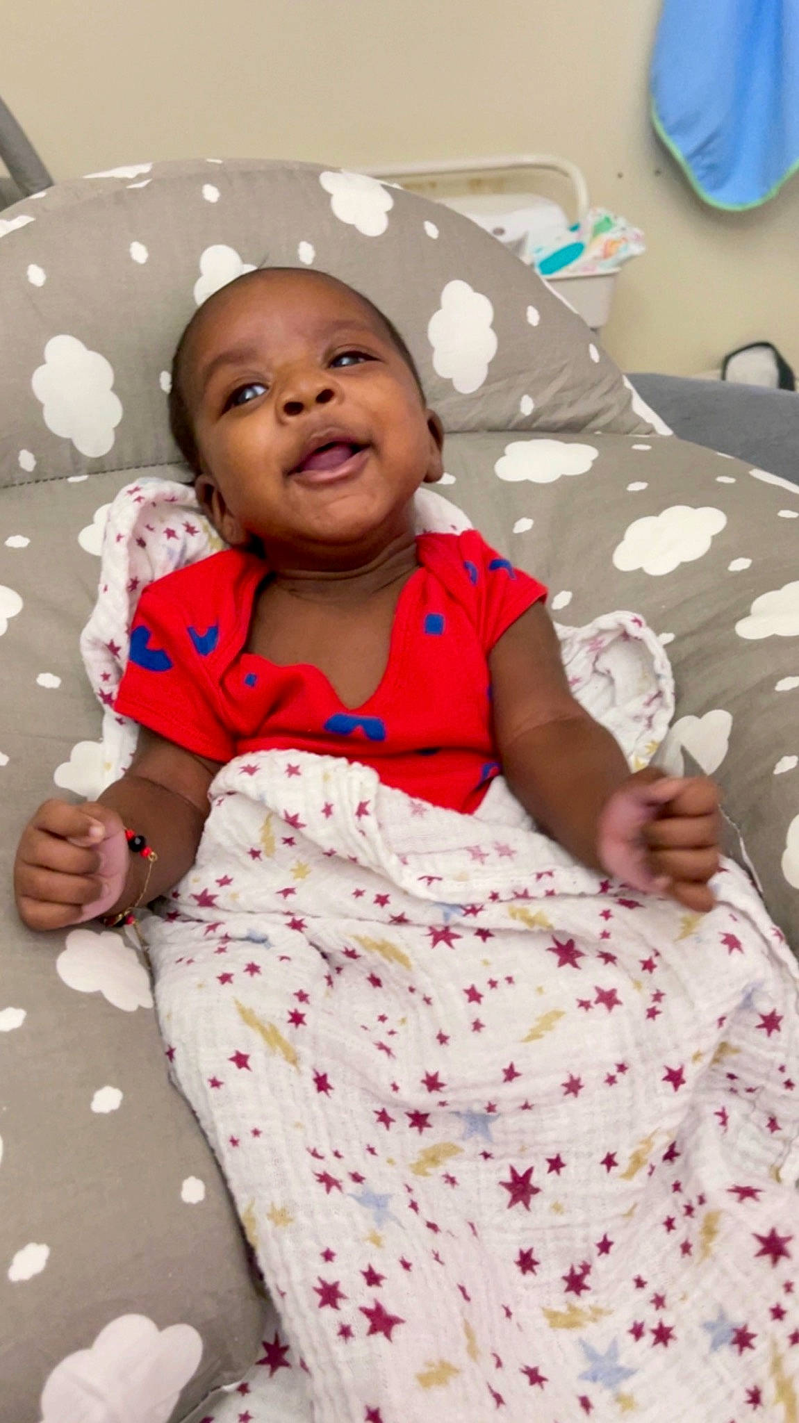 Kai is registered to the contest to win money with this photo: baby, baby_toddler_clothing, bedding, cheek, child, comfort, fun, happy, linens, magenta, pattern, person, pink, portrait_photography, room, sitting, sleeve, smile, t_shirt, textile