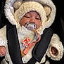 baby, infant, pacifier, fuzzy_hood, bear_ears, white_fur, car_seat, seat_harness, straps, pacifier_clip, hooded_coat, winter_clothing, soft_texture, closeup, portrait, hand, adorable, sleepy, black_background, cute_accessory