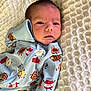 Cole joined the competition — help win amazing prizes! baby, newborn, onesie, blue_clothing, blanket, face, infant, sleepy, cute, portrait, lying_down, soft_texture, bedroom, indoors, child, person, jam_jar_print, food_pattern, warm, cozy