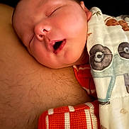 Cole is registered to the contest to win money with this photo: baby, blanket, chest, child, closed_eyes, comfort, cozy, cute, face, infant, mouth_open, newborn, pattern, peaceful, portrait, resting, skin, sleeping, soft, warm