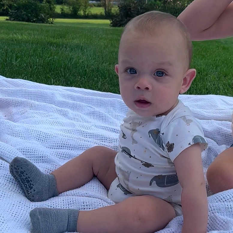 Braydon joined the competition — help win amazing prizes! baby, child, outdoor, grass, blanket, onesie, socks, person, infant, nature, greenery, sky, clouds, summer, cute, portrait, sitting, young, casual, daylight