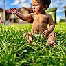 baby, child, toddler, sitting, grass, outdoor, portrait, sunlight, sky, clouds, neighborhood, house, nature, barefoot, curious, serious_expression, hand_gesture, short_hair, infant, photography