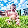 baby, child, infant, sitting, outdoors, grass, lawn, portrait, face, serious, fist, barefoot, shirtless, diaper, greenery, sky, clouds, buildings, daylight, photography