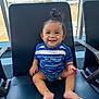 toddler, child, smiling, sitting, airport, chair, blue_shirt, denim_shorts, pony_tail, happy, indoor, window, daylight, runway, airplane, footwear_free, person, cute, casual_clothing, waiting_area