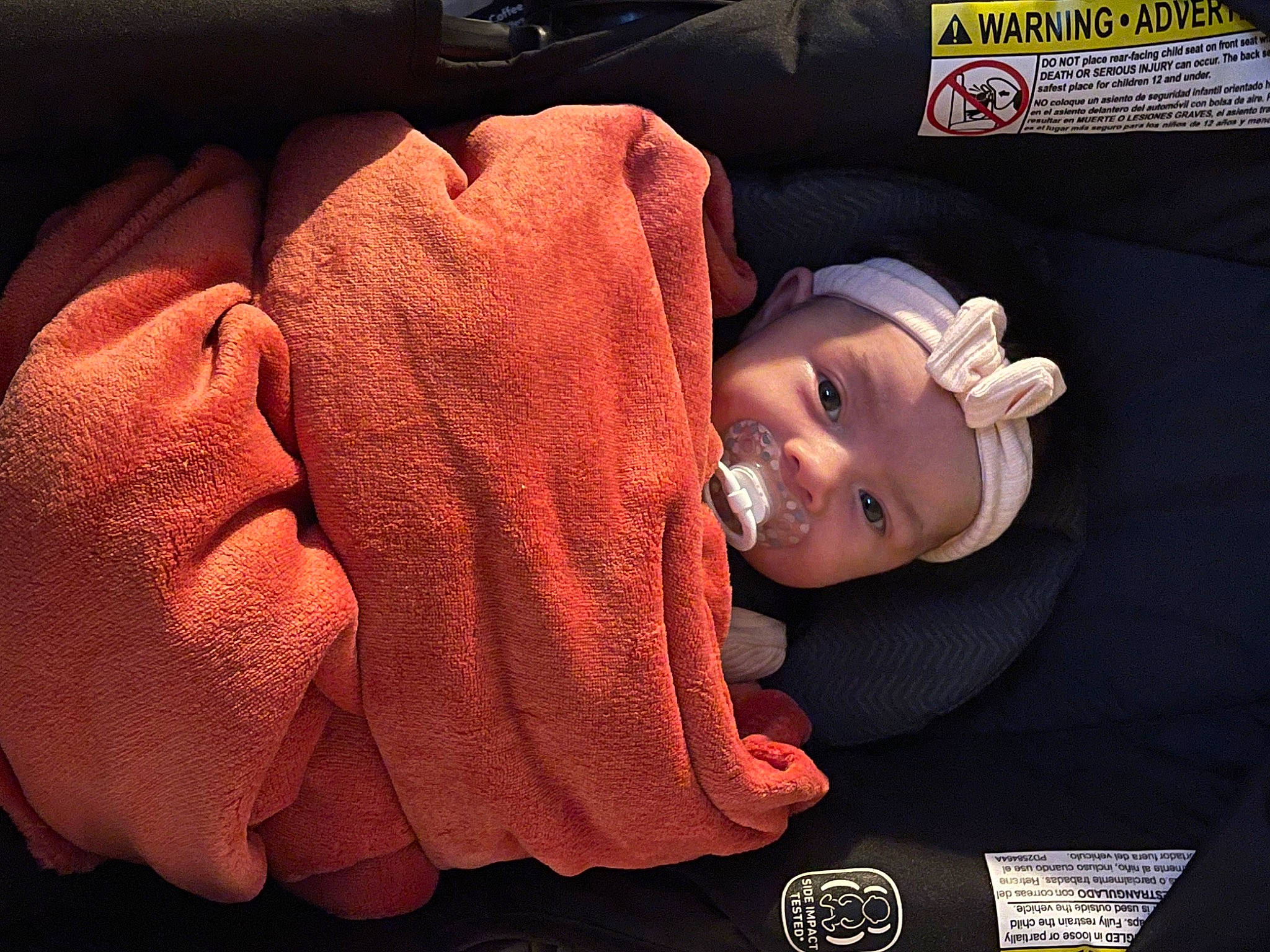Margot is registered to the contest to win money with this photo: auto_part, automotive_lighting, baby, baby_products, baby_toddler_clothing, cap, car_seat, carmine, child, comfort, fashion_accessory, fun, hat, headgear, headwear, mouth, person, skin, smile, thumb