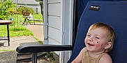 Astella joined the competition — help win amazing prizes! toddler, child, smiling, stuffed_animal, outdoor_chair, patio, garden, sunny_day, blue_chair, clothing, happy, face, short_hair, plush_toy, concrete_floor, house_exterior, greenery, daylight, casual, relaxed