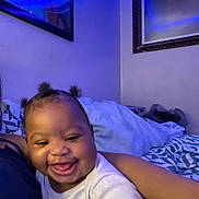 Kyezen joined the competition — help win amazing prizes! baby, smiling, indoor, blue_light, person, child, happy, bed, pillow, hair, face, cute, infant, cozy, blanket, toddler, clothing, portrait, home, joy