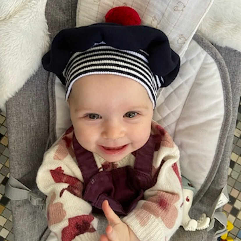 Matilda participe au concours pour gagner de l'argent avec cette photo : baby, bodypart, bonnet, cap, clothing, coat, cushion, face, finger, glove, hand, happy, hat, head, homedecor, jacket, person, photography, portrait, smile