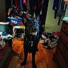 animal, bedroom, black_dog, canine, clothes, cluttered_room, collar, dog, dog_bowl, domestic_animal, dresser, fabric, furniture, happy, home_interior, indoor, laundry_basket, pet, standing, wooden_floor