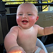 Parker joined the competition — help win amazing prizes! baby, child, smiling, happy, rosy_cheeks, seat, straps, outdoor, sunlight, skin, face, hand, arm, blue_eyes, bald, infant, cute, pointing, closeup, portrait