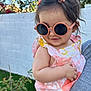 Azalea joined the competition — help win amazing prizes! toddler, child, sunglasses, hair_bows, floral_dress, person, outdoor, garden, greenery, white_wall, flowers, cute, smiling, summer, sunny, holding, arm, casual_clothing, portrait, happy