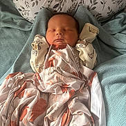 Casey is registered to the contest to win money with this photo: newborn, baby, sleeping, blanket, animal_print, pillow, bed, cozy, soft, infant, cute, peaceful, wrapped, fabric, textured, resting, child, indoors, portrait, comfort