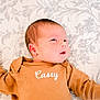 Casey joined the competition — help win amazing prizes! baby, newborn, infant, onesie, brown_clothing, lying_down, quilt, floral_pattern, face, head, skin, hand, cute, child, portrait, indoors, soft_lighting, sleepwear, young_child, person