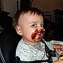 Killian joined the competition — help win amazing prizes! child, toddler, chocolate, messy_face, highchair, eating, food, smile, indoor, shirt, harness, hand, portrait, close_up, living_room, furniture, photos_on_wall, walker, happy, baby_food