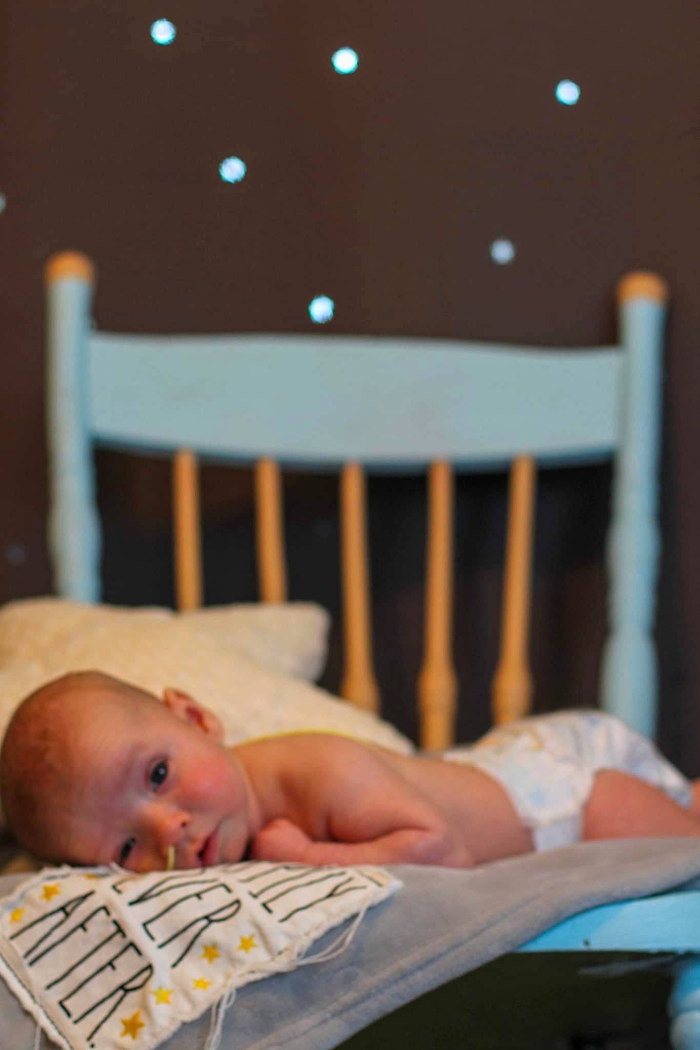 Ezio joined the competition — help win amazing prizes! arm, baby, baby_products, baby_safety, baby_toddler_clothing, bed, child, comfort, event, finger, happy, infant_bed, linens, mammal, person, product, room, sitting, skin, textile