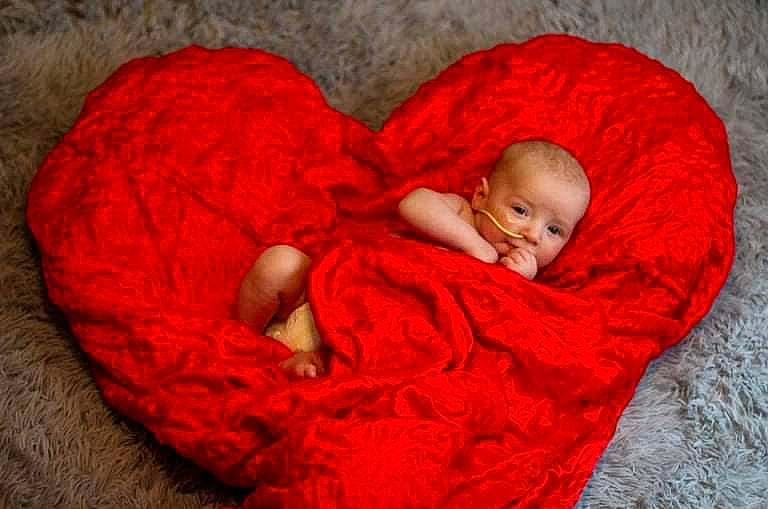 Ezio joined the competition — help win amazing prizes! baby, baby_sleeping, baby_toddler_clothing, bedtime, carmine, child, comfort, face, grass, head, human_body, knit_cap, linens, outerwear, person, plant, textile, toddler, wood, wool