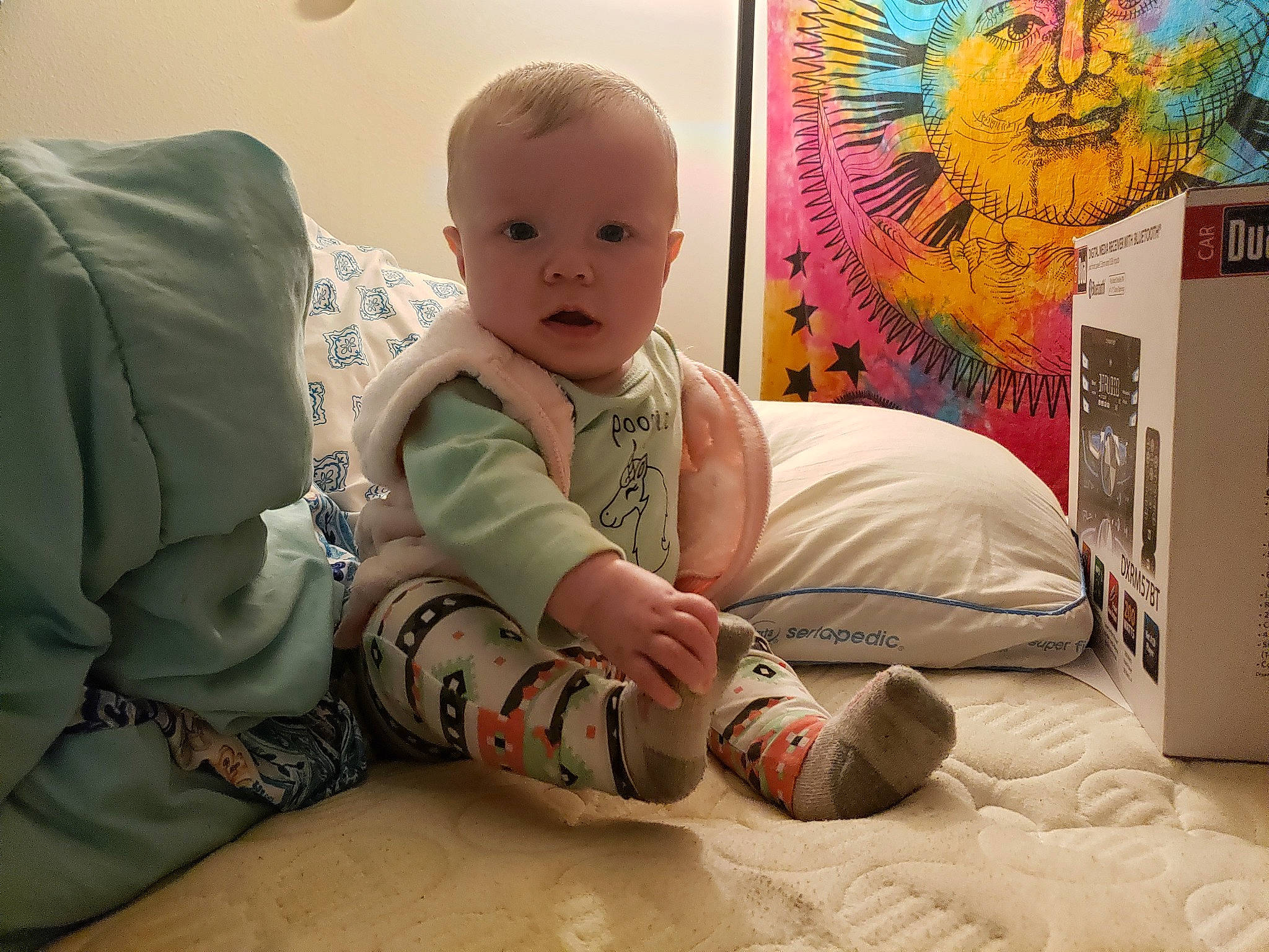 Phoebe is registered to the contest to win money with this photo: baby, baby_toddler_clothing, bedding, child, comfort, flooring, fun, linens, pattern, person, play, publication, room, sitting, skin, sleeve, textile, toddler, visual_arts
