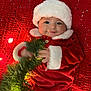baby, christmas, holiday, red, santa_hat, santa_suit, knitted_blanket, lights, greenery, festive, cute, infant, holiday_decor, smile, portrait, cozy, indoors, celebration, child, winter