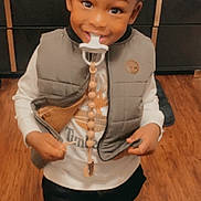 Braxton joined the competition — help win amazing prizes! toddler, child, indoor, smiling, vest, pacifier, clothing, wooden_floor, black_pants, black_shoes, happy, person, standing, cute, young_child, home, casual_wear, face, portrait, baby
