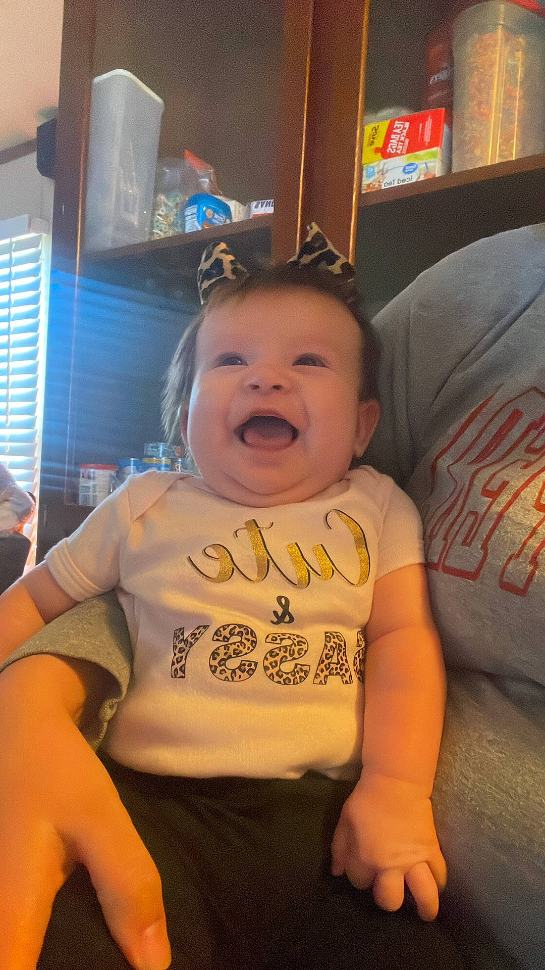 Amelia joined the competition — help win amazing prizes! abdomen, baby, baby_toddler_clothing, chair, cheek, child, comfort, cool, facial_expression, fun, happy, laugh, mouth, person, room, sitting, sleeve, smile, t_shirt, toddler