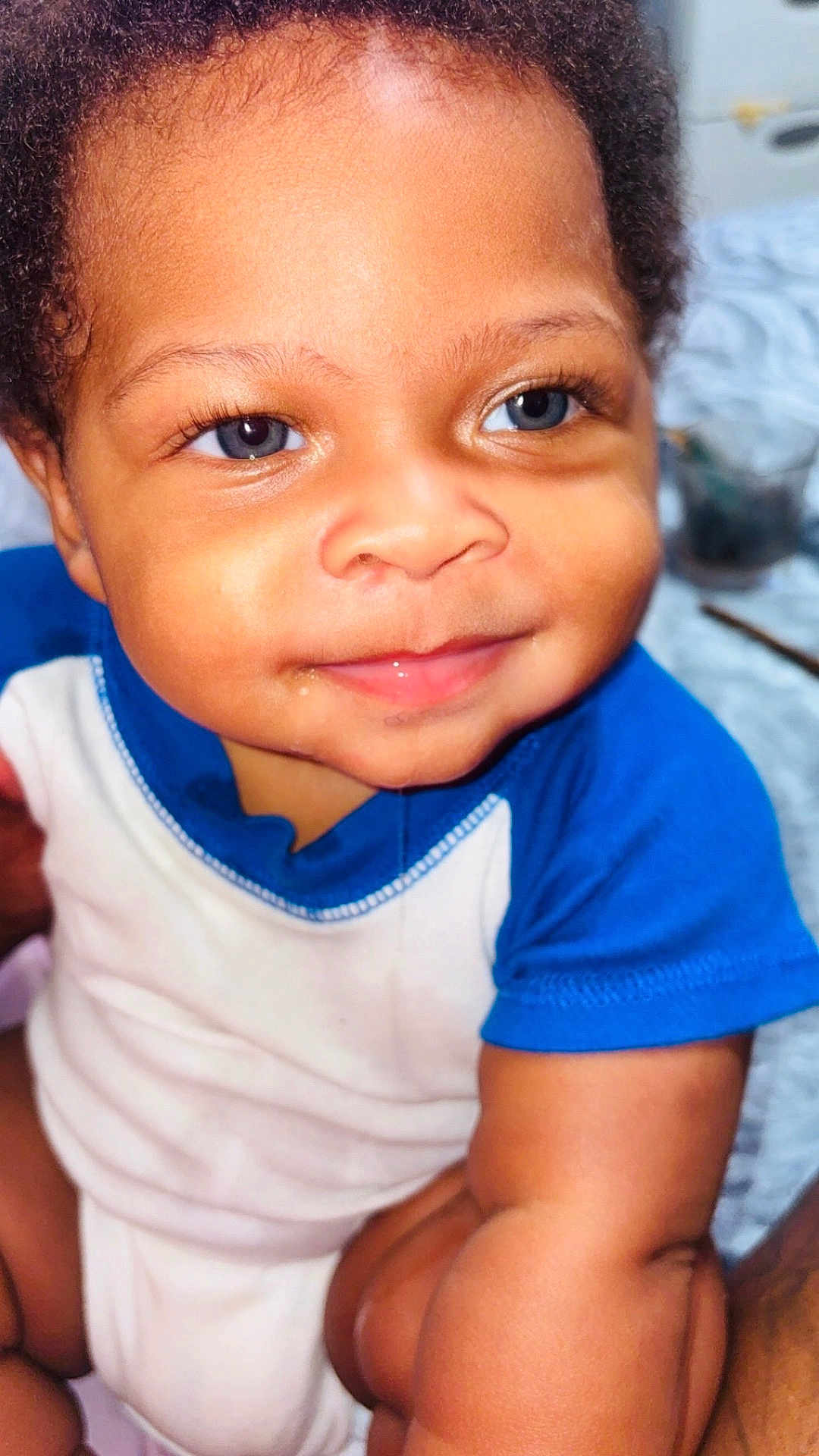 Jahkai Jean joined the competition — help win amazing prizes! baby, infant, child, smiling, face, blue_eyes, onesie, cute, closeup, skin, arm, portrait, happy, young, person, indoors, curly_hair, expression, baby_clothes, soft_lighting