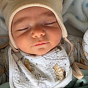 David joined the competition — help win amazing prizes! baby, sleeping, hat, bear_ears, bib, blanket, soft_texture, cute, peaceful, infant, clothing, closeup, face, headwear, resting, indoors, cozy, child, portrait, warm