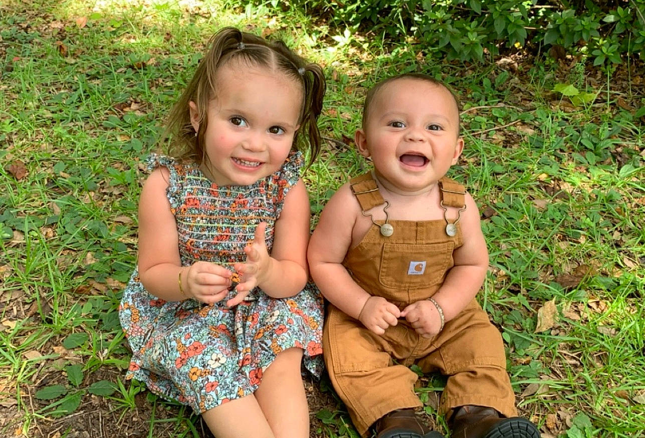 Castiel is registered to the contest to win money with this photo: baby, child, family, fun, grass, joy, people, person, photograph, photography, plant, sibling, sitting, smile, toddler