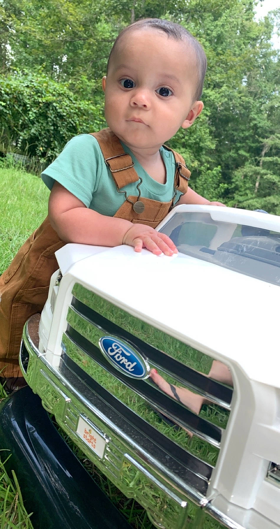Castiel is registered to the contest to win money with this photo: automotive_exterior, automotive_window_part, bumper, car, child, family_car, ford, ford_motor_company, grille, person, plant, product, toddler, vehicle