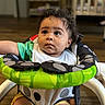 Marciano joined the competition — help win amazing prizes! baby, child, infant, walker, green, black, white, polka_dots, curly_hair, indoors, wooden_floor, crib, shelf, clothing, bib, seat, looking_up, cute, young, portrait
